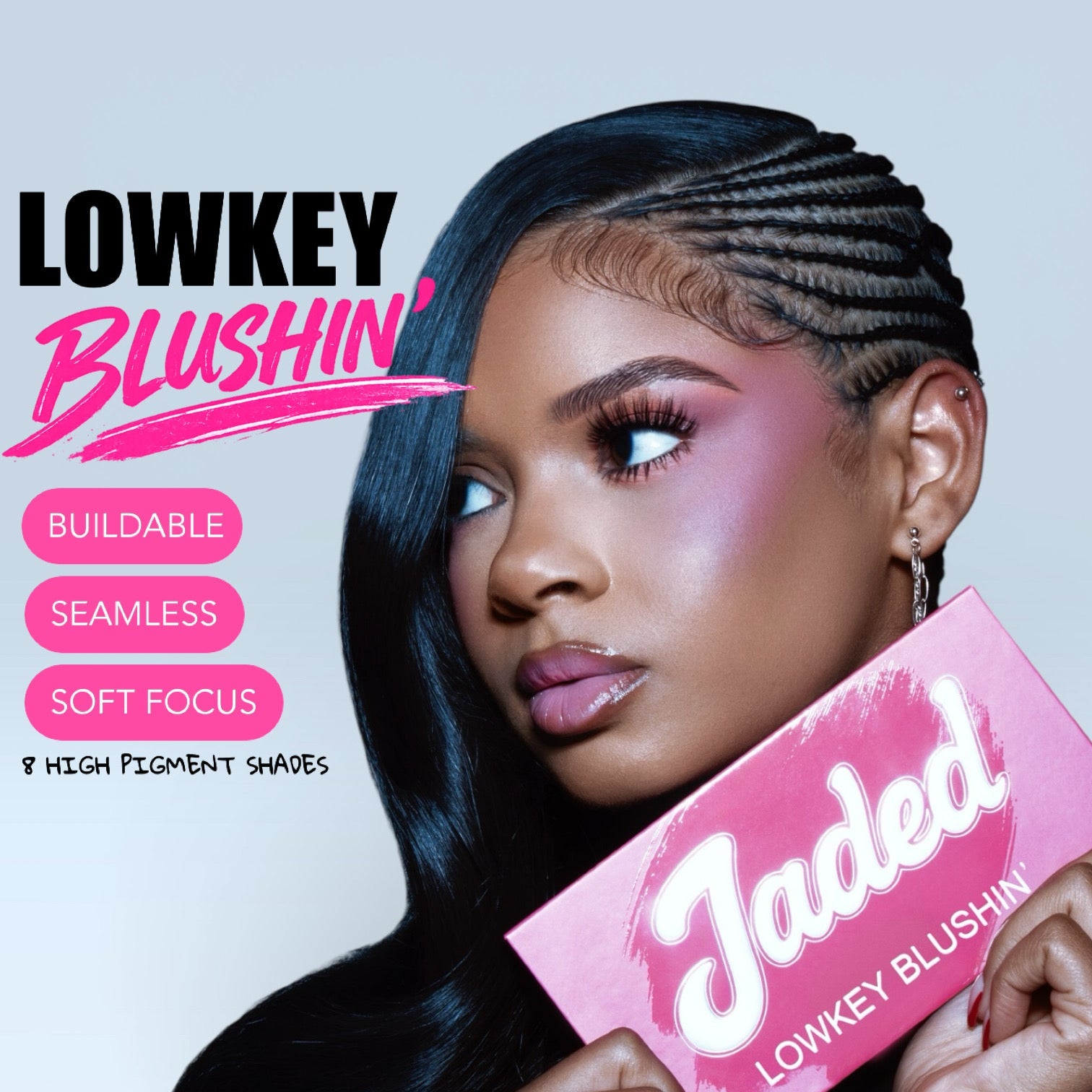 Woman holding a pink makeup product with 'LOWKEY BLUSHIN' branding on a light purple background